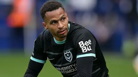 Josh Murphy crouches down during a Portsmouth game