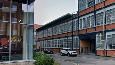 A two-storey building next to a four-storey building in Henshaw Street