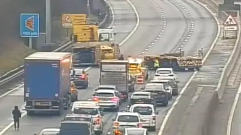 Highways England Traffic camera footage showing the trailer across the M1 southbound and traffic being held. 