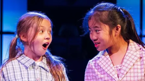 Drummer Television/BBC Two children are wearing costumes and performing on a stage