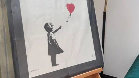 Nick Johnson The Girl with Balloon picture that was stolen and since recovered. It is of a young girl who is reaching for a heart-shaped balloon that's floating away