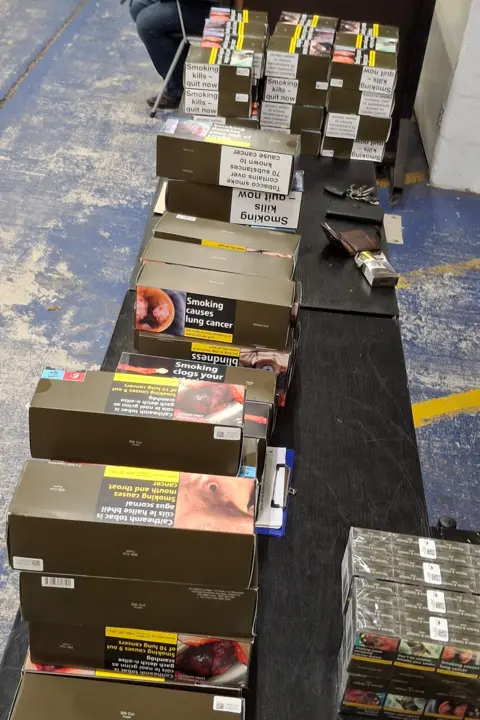 Home Office Boxes of cigarettes on a desk.