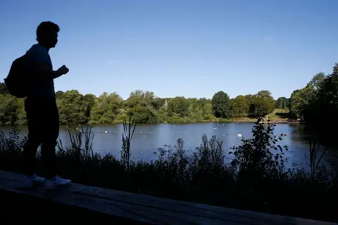 Getty Images Hampstead Heath men's bathing pond reopens to the public on July 11, 2020 in London, England. The UK Government announced that outdoor swimming ponds and lidos can reopen this Saturday after closing to prevent the spread of Coronavirus. (Photo by Hollie Adams/Getty Images)
