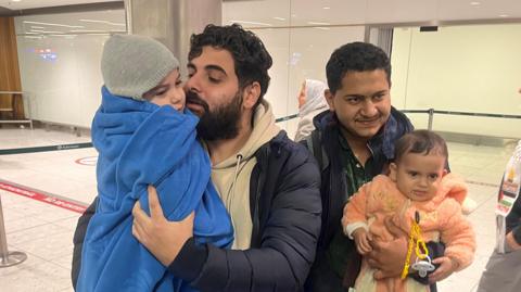 Khalid El-Estal, four year old son Ali and one year old daughter Sara in Dublin Airport with their uncle Mohammed Jendia
