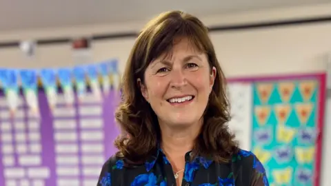 Holy Trinity CofE Academy A woman in a blue and black dress