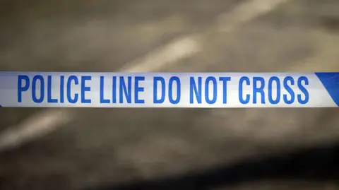 PA Media Police tape reading 'Police line do not cross'