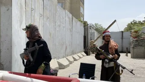 EPA Taliban militants with rifles in Kabul on 17 August 2017