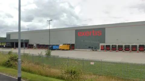 Exertis UK's main distribution centre in Burnley is a large grey warehouse with numbered loading bays