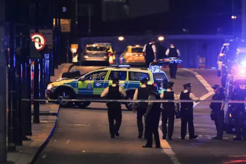 Getty Images Police officers walk at the scene of a terror attack on London Bridge in central London on 3 June 3 2017