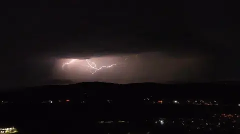 Lightning by Raymond McCarron in a dark night sky.