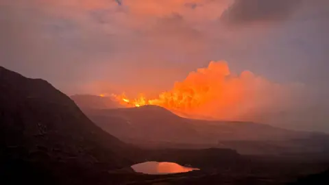 A large fire over the Mourne Mountains at twilight 