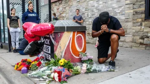 AFP A protester prays in front of the memorial of George Floyd who died in custody on May 26, 2020 in Minneapolis, Minnesota