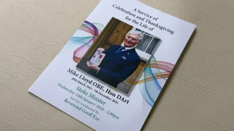 The order of service has a photo of a man on the front. Words include Mike Lloyd OBE, Hon DArt.