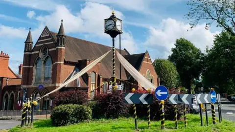 Scott Crowther Roundabout draped in ribbon