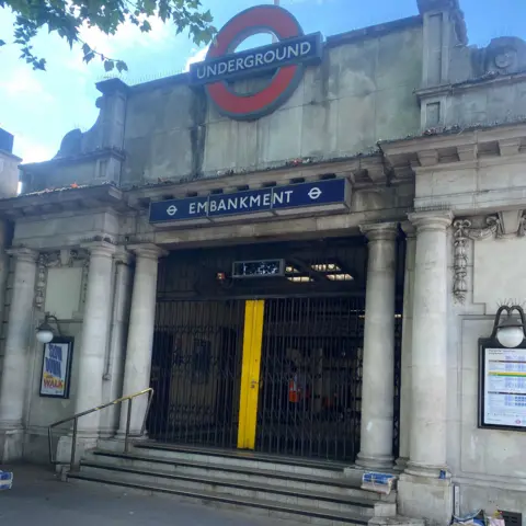 The entrance to Embankment station with gates pulled across it
