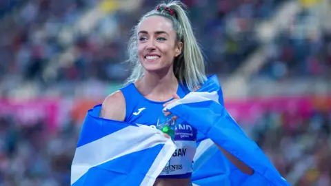 Eilish McColgan draped in a Saltire after a successful race