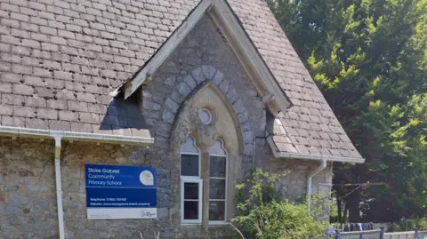 Stoke Gabriel Community Primary School with a sign on its side with the name of the school.
