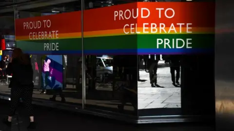 Getty Images Shop with rainbow flag sticker in window and 'proud to celebrate pride' message