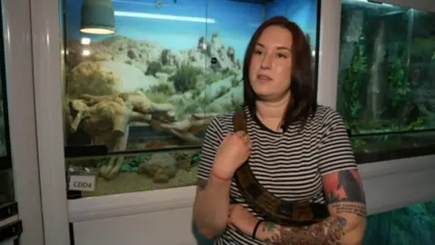 Volunteer Taylor Port-Forbes holding a snake