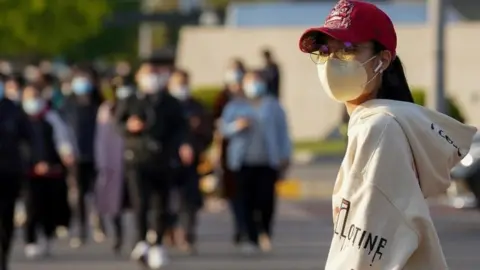 Getty Images Woman wearing mask in Beijing - 23 April