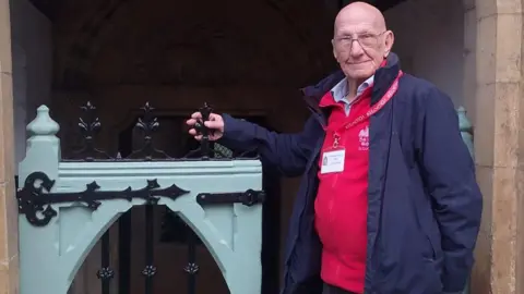 Tony Aldridge joined Alan in stripping back some blue and black gates in to St Nicholas Church on Westgate and repainting them and he is standing next to them. 
