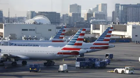 EPA American Airlines planes parked at gates.