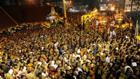 Getty Images Hindu devotees pray at the Sabarimala temple during the Maravilakku festival marking the final of a two-month pilgrimage to the Lord Ayyappa temple in Kerala, south India on January 14, 2011.