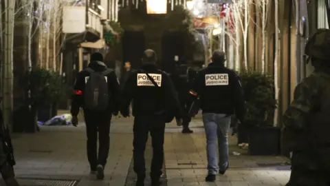 Anadolu Agency/Getty Images French police officers inspect the deadly shooting site at the Christmas market in Strasbourg, France, 11 December 2018