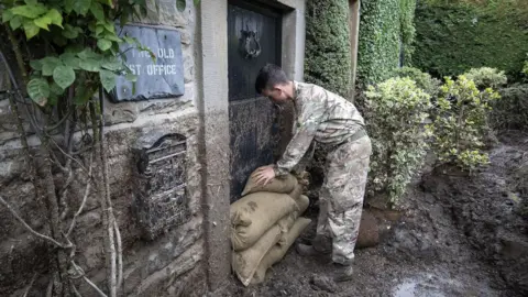 PA Media Soldier stacking sandbags in front of the old post office front door