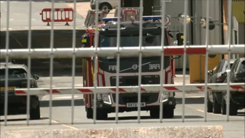 A fire engine behind a metal gate