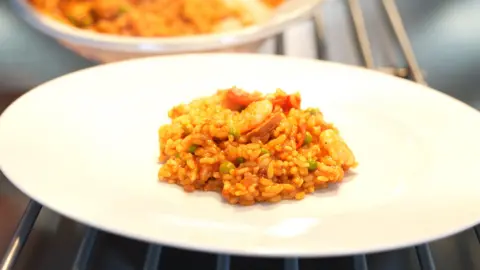 Oscar Mayer Limited Close up shot of a prawn and chorizo paella dish in the centre of a large white plate. 