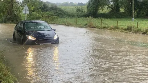 Shannon Eustace/BBC Car in flooded road in Flowton