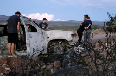 Getty Images One of the cars was burned after the attack