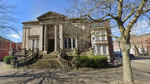 The Harris Institute, Preston, a large light stone building with tall columns at the large door entrance, and steps lead up to it in the autumn sunshine