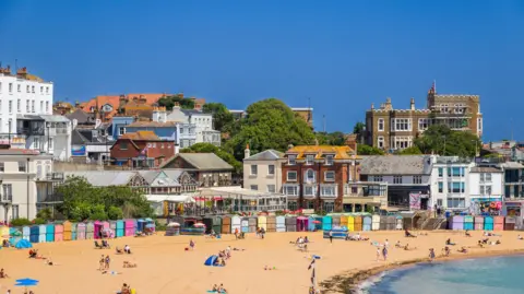 A sandy beach and pretty English-seaside town. 