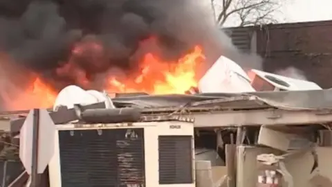 Fire billowing out of the partially collapsed nursing home building