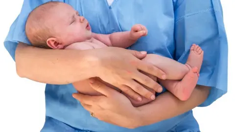 Getty Images Midwife with baby