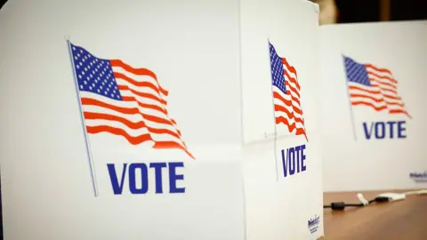 US flags on a voting booth