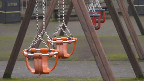 Empty swings in a playground