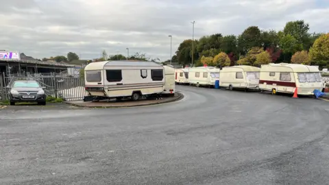 Caravans seen parked along the road near the M32. 