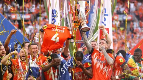 Getty Images Luton Town players celebrate promotion