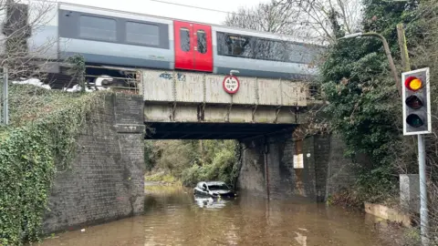 Essex County Fire and Rescue Service Car stuck under railway bridge