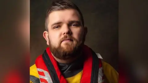 RNLI Weston-super-Mare Chris Lyons. He is wearing RNLI kit and is looking directly at the camera.