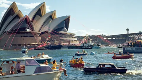 National Archives of Australia People gather in Sydney harbour to watch the 1973 opening ceremony