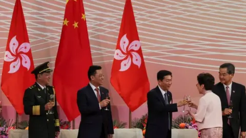 Reuters Luo Huining, pictured right of centre toasting with Hong Kong Chief Executive Carrie Lam