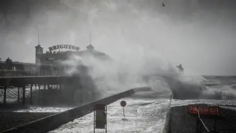 Getty Images Waves crashing against Brighton pier during Storm Eunice