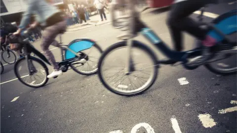 Getty Images people riding bicycles on city street