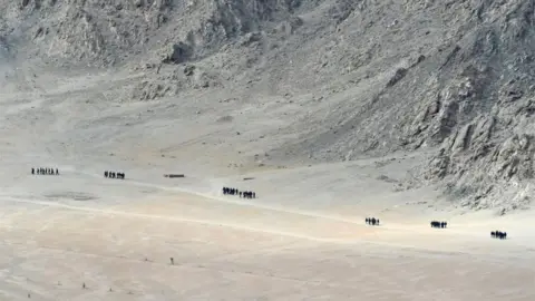 AFP Indian soldiers walk at the foothills of a mountain range near Leh, the joint capital of the union territory of Ladakh, on June 25, 2020.