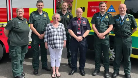 Lancashire Fire and Rescue Service Diane Fenton with emergency team who helped her