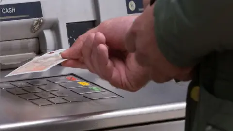 Man withdrawing cash from an ATM